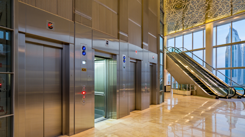 Modern elevator and escalator safety systems in a UAE building demonstrating the Difference Between Elevator and Escalator in UAE.