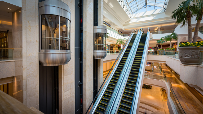 Comparison of elevators and escalators in a commercial property highlighting the Difference Between Elevator and Escalator in UAE.
