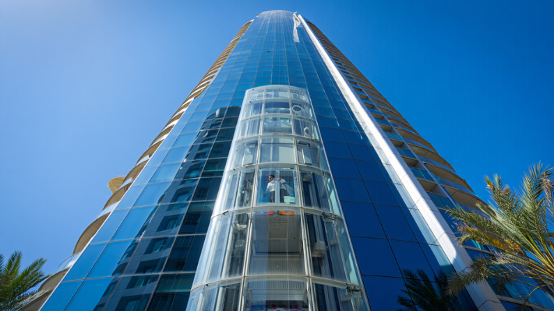Modern tower elevator with transparent panoramic cabin installed in a high-rise building featuring premium glass elevators in UAE